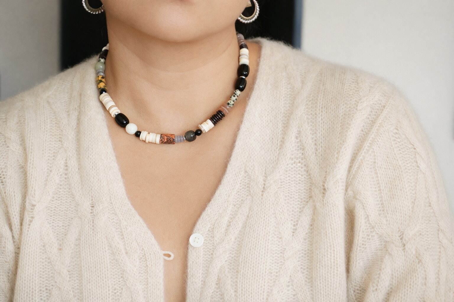 Mixed natural stone necklace worn with a cream knit