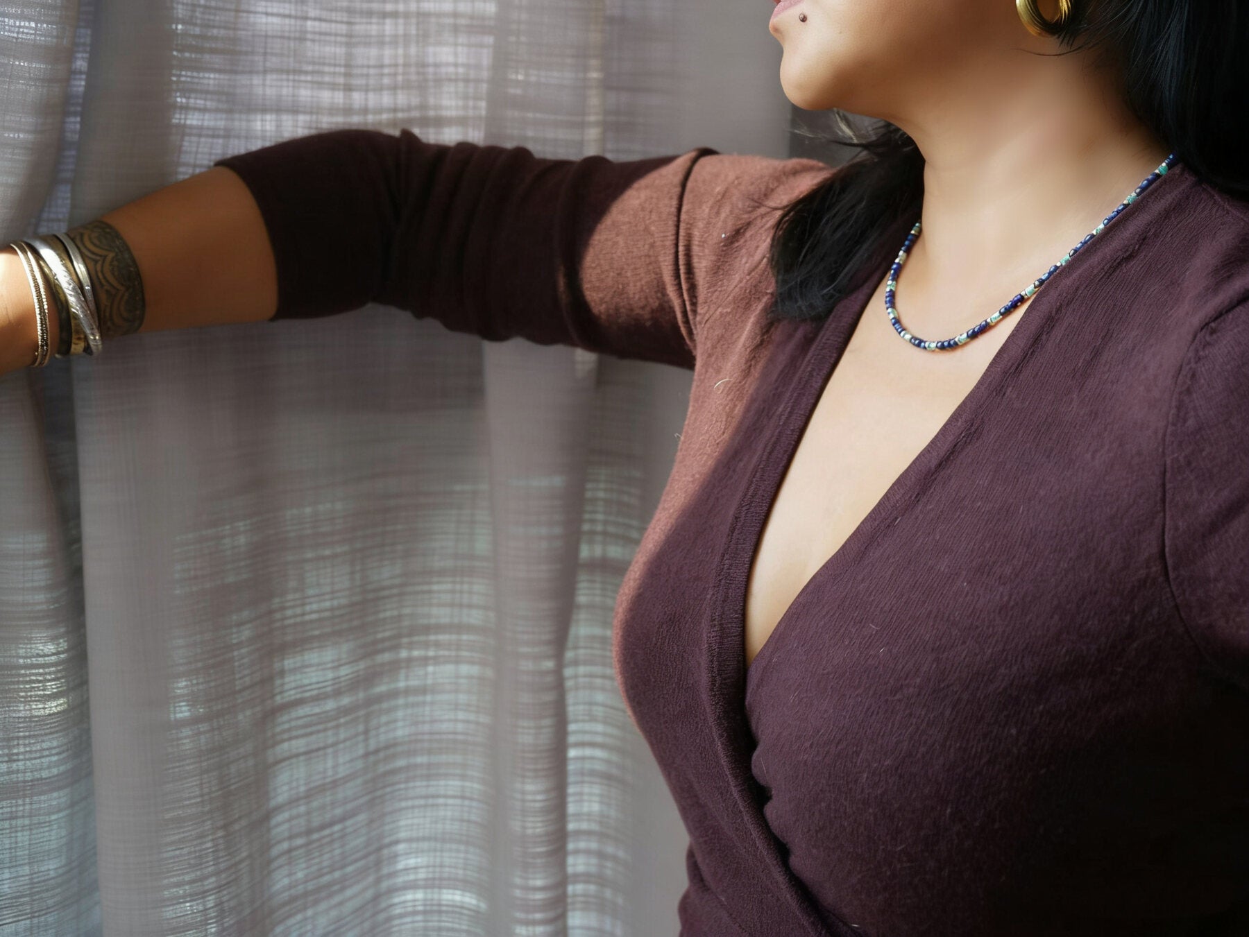 Fine lapis and turquoise necklace worn with a deep plum top